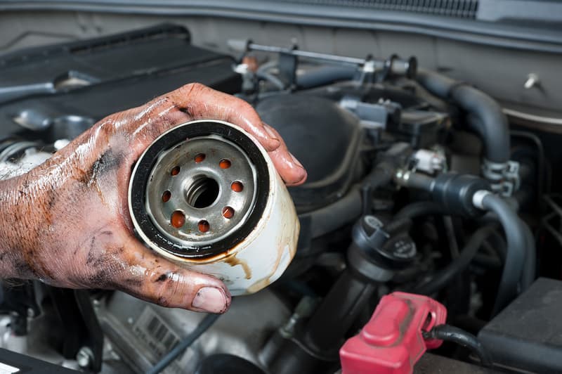 Mechanic holding oil filter
